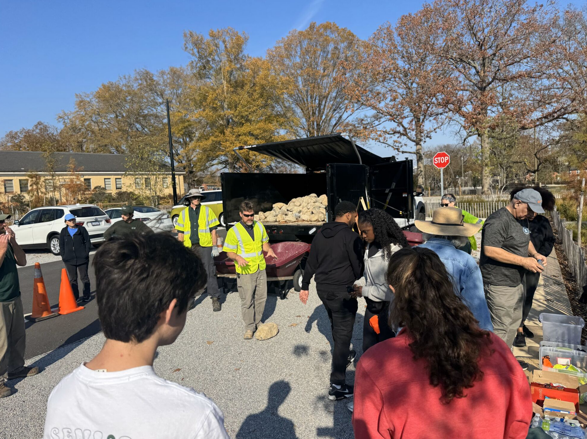 People gathered around a food truck at an outdoor event on a sunny day.