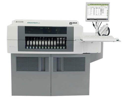 Una máquina gris y blanca con una computadora encima.