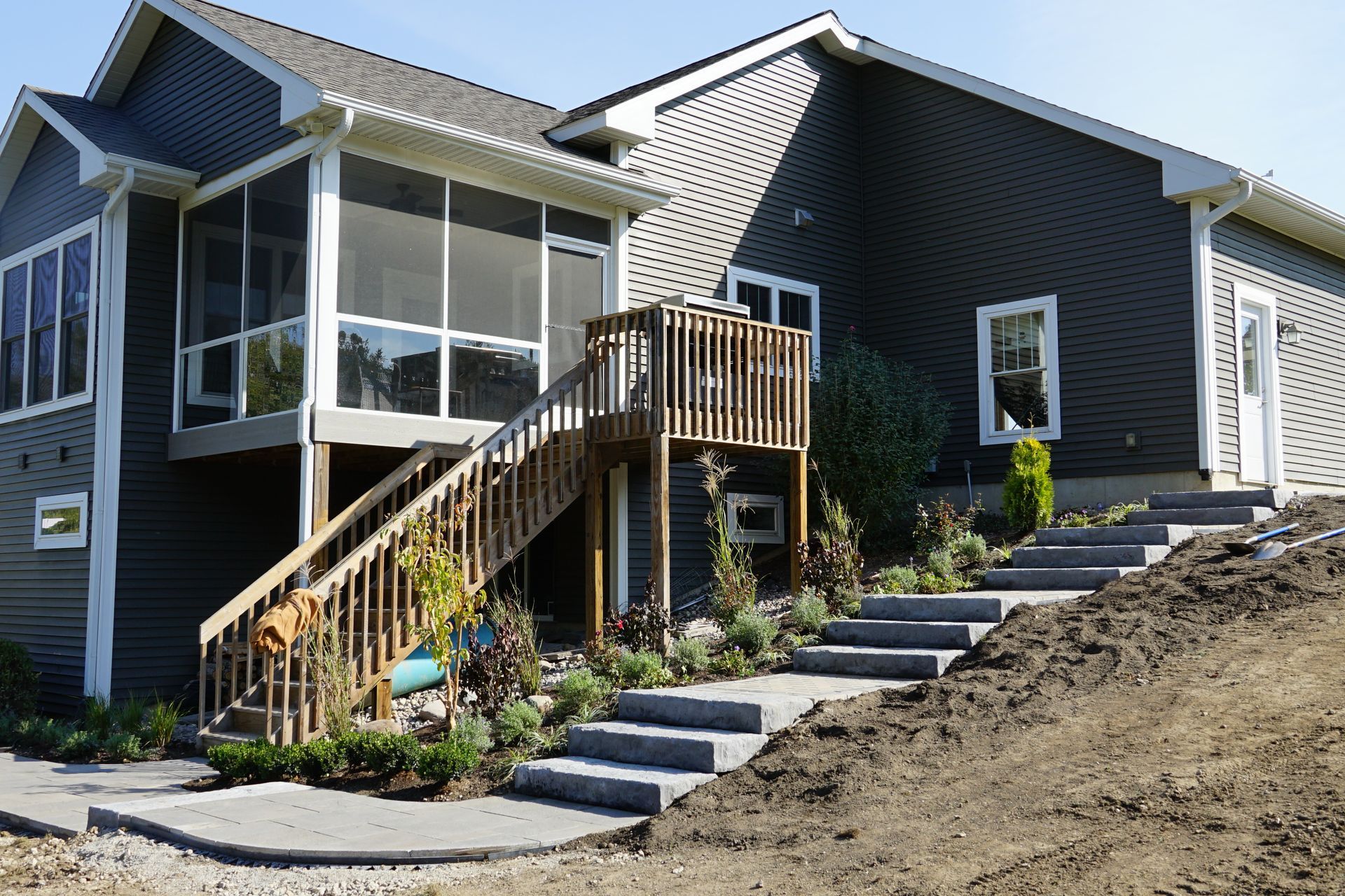 A house with stairs leading up to it and a screened in porch