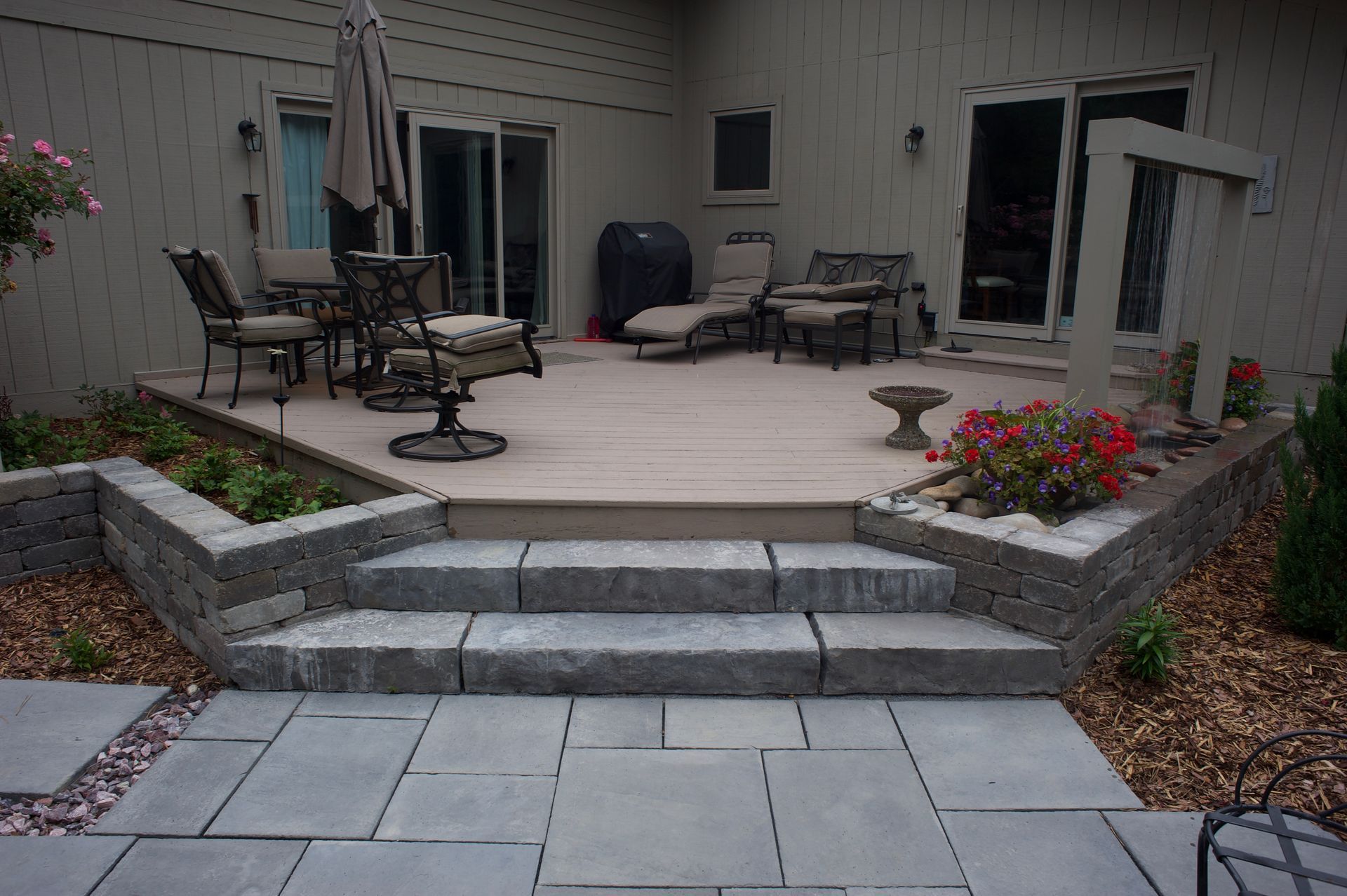 A patio with a table and chairs on it