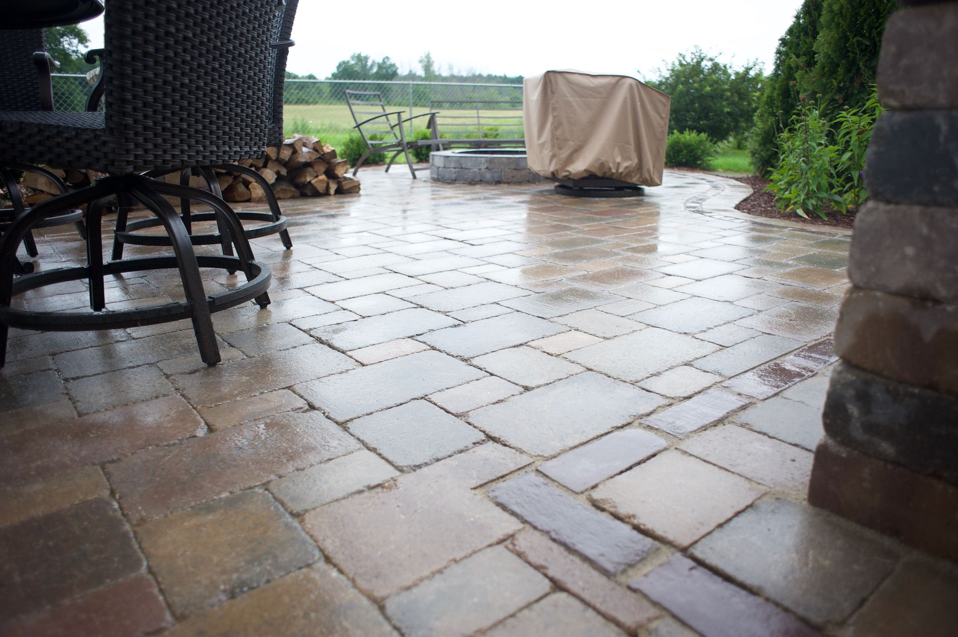 A patio with a table and chairs and a fire pit