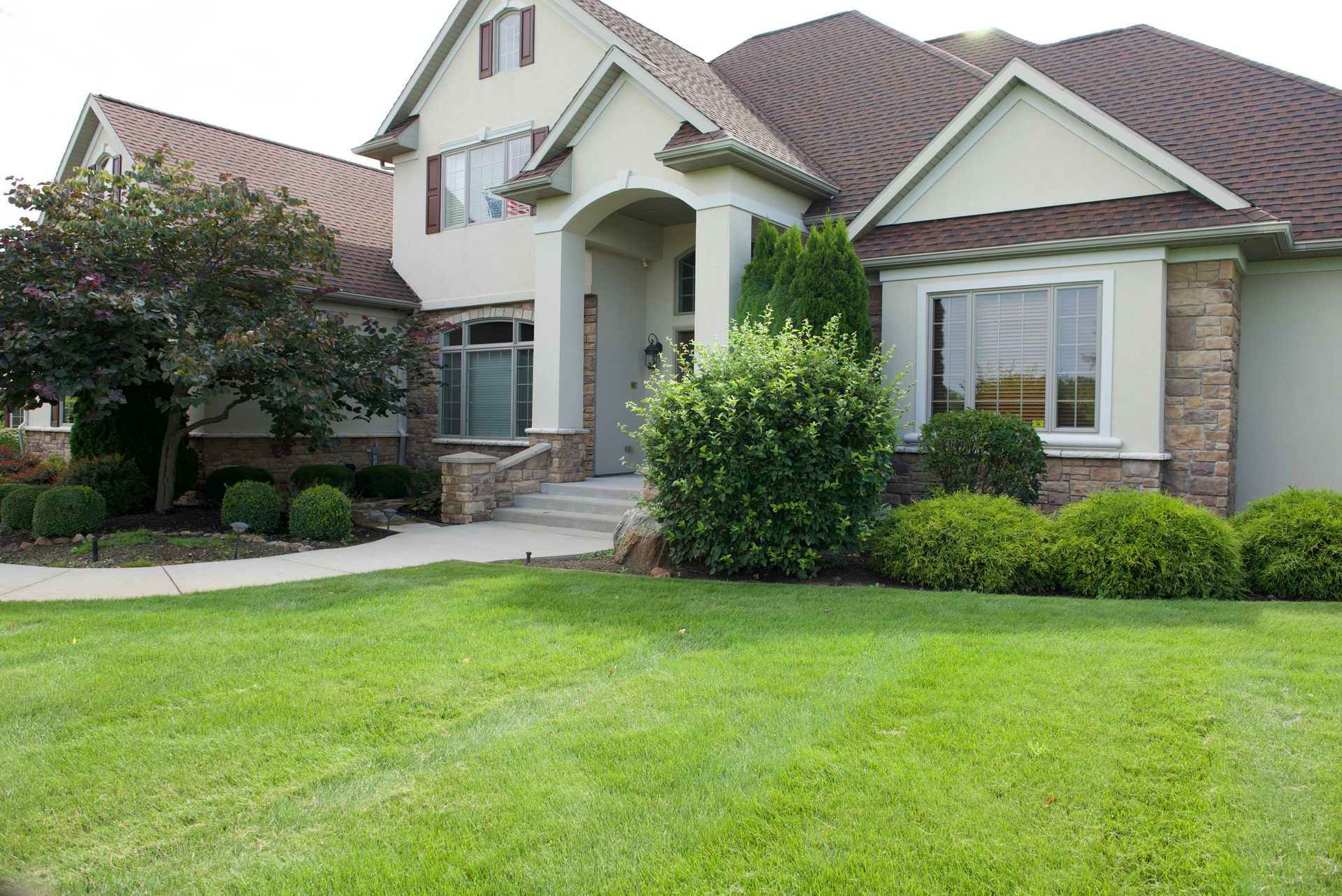 A large house with a lush green lawn in front of it