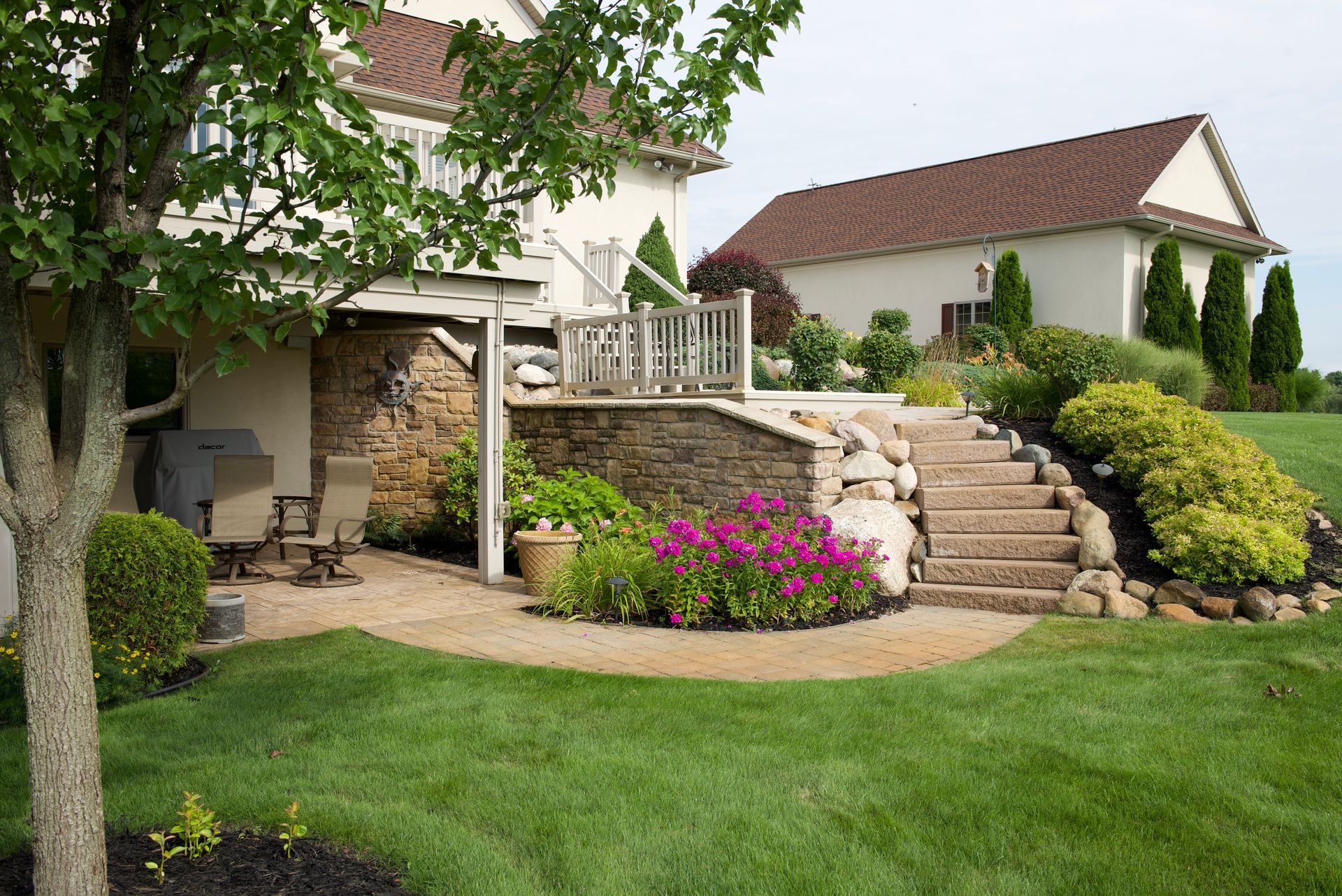 A house with a large lawn and stairs leading up to it
