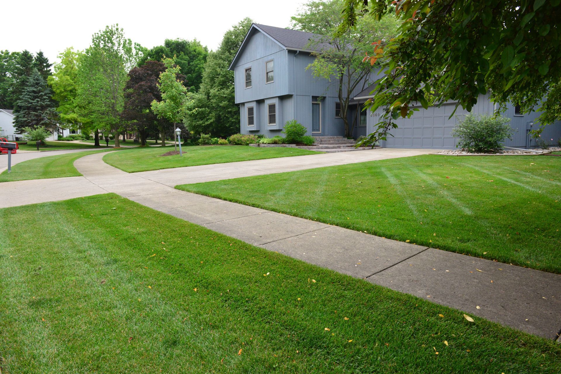 A large house with a lush green lawn in front of it