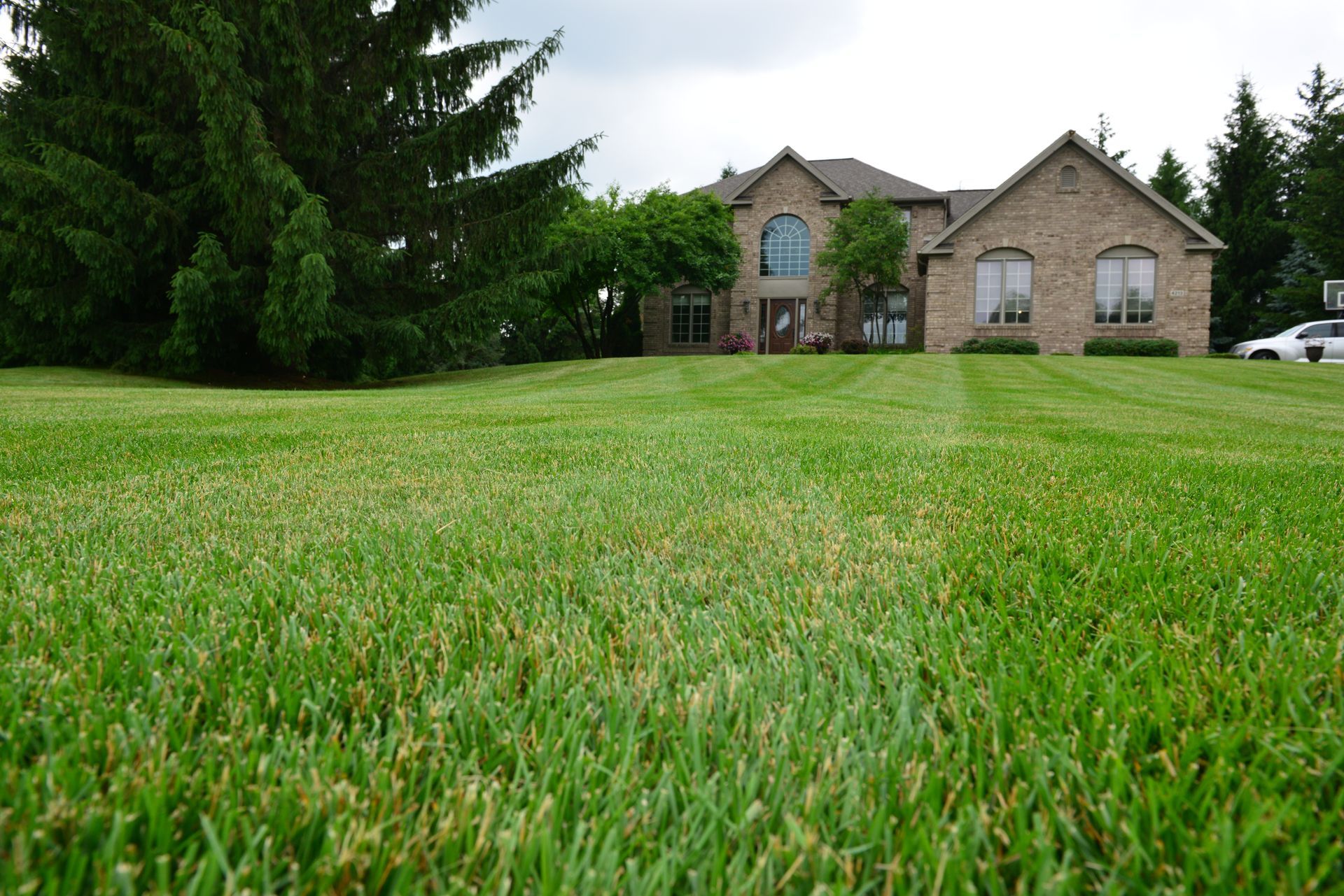 A large house with a lush green lawn in front of it
