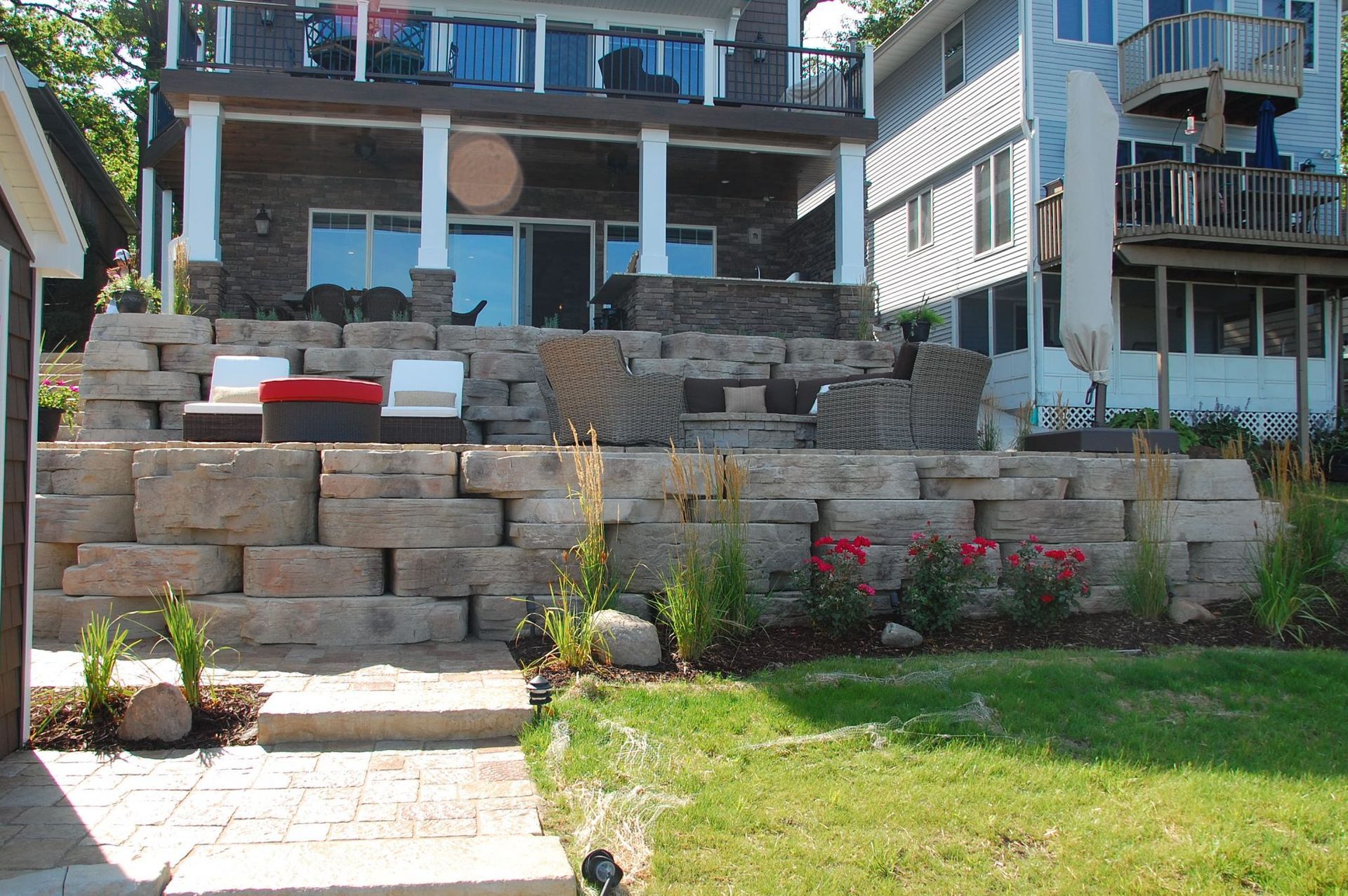 A large house with a large stone wall in front of it