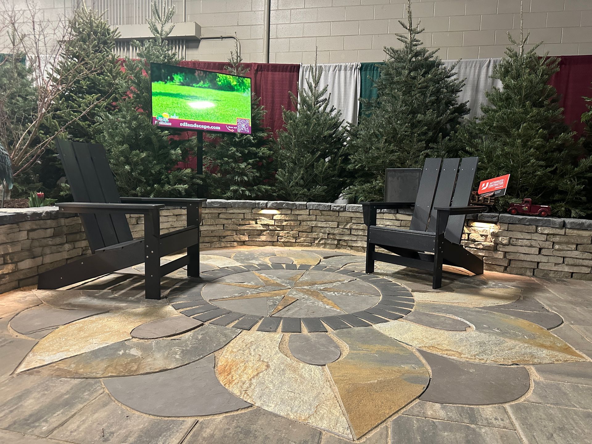Two chairs are sitting on a patio in front of a television.