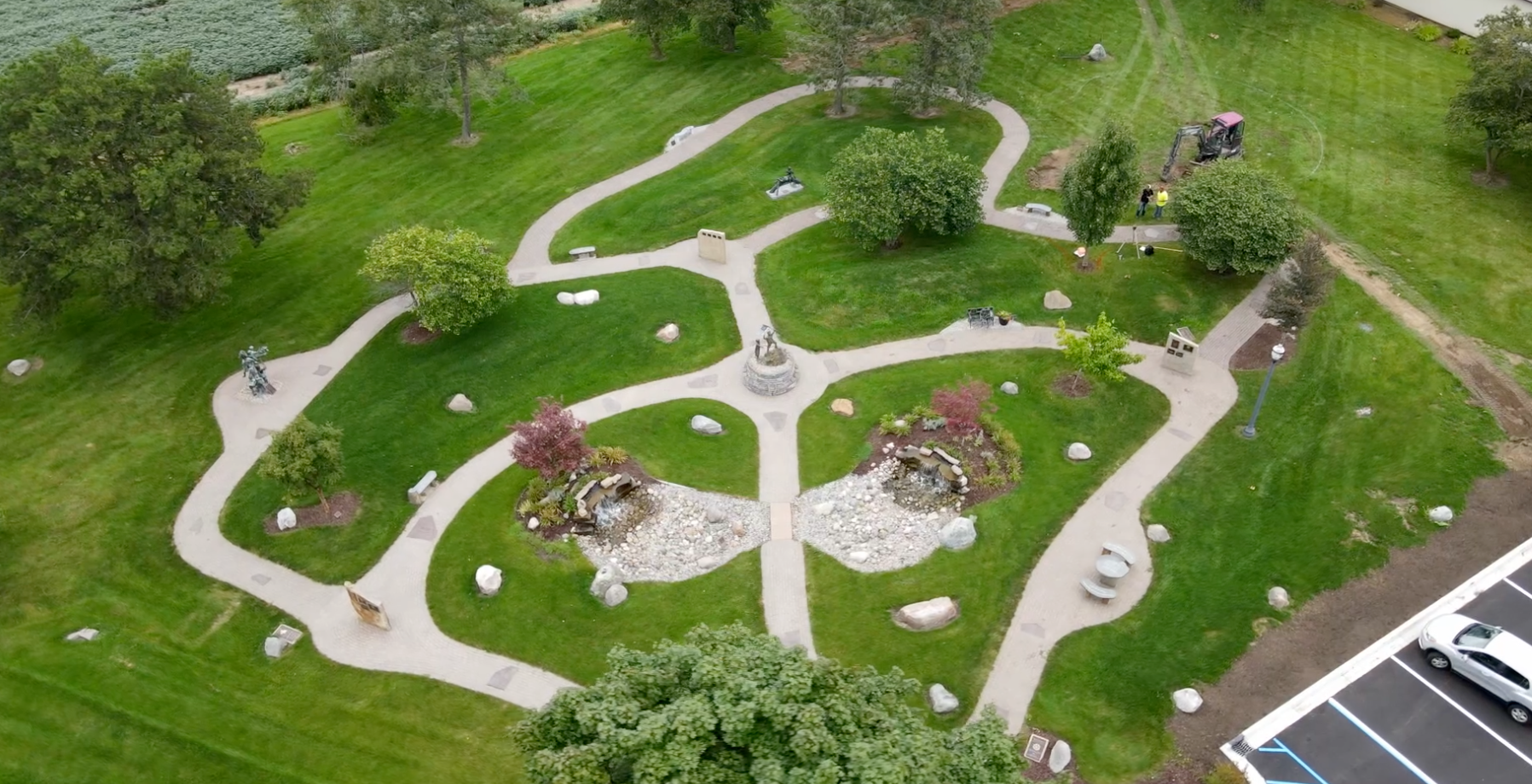 An aerial view of a park with a maze in the middle of it.