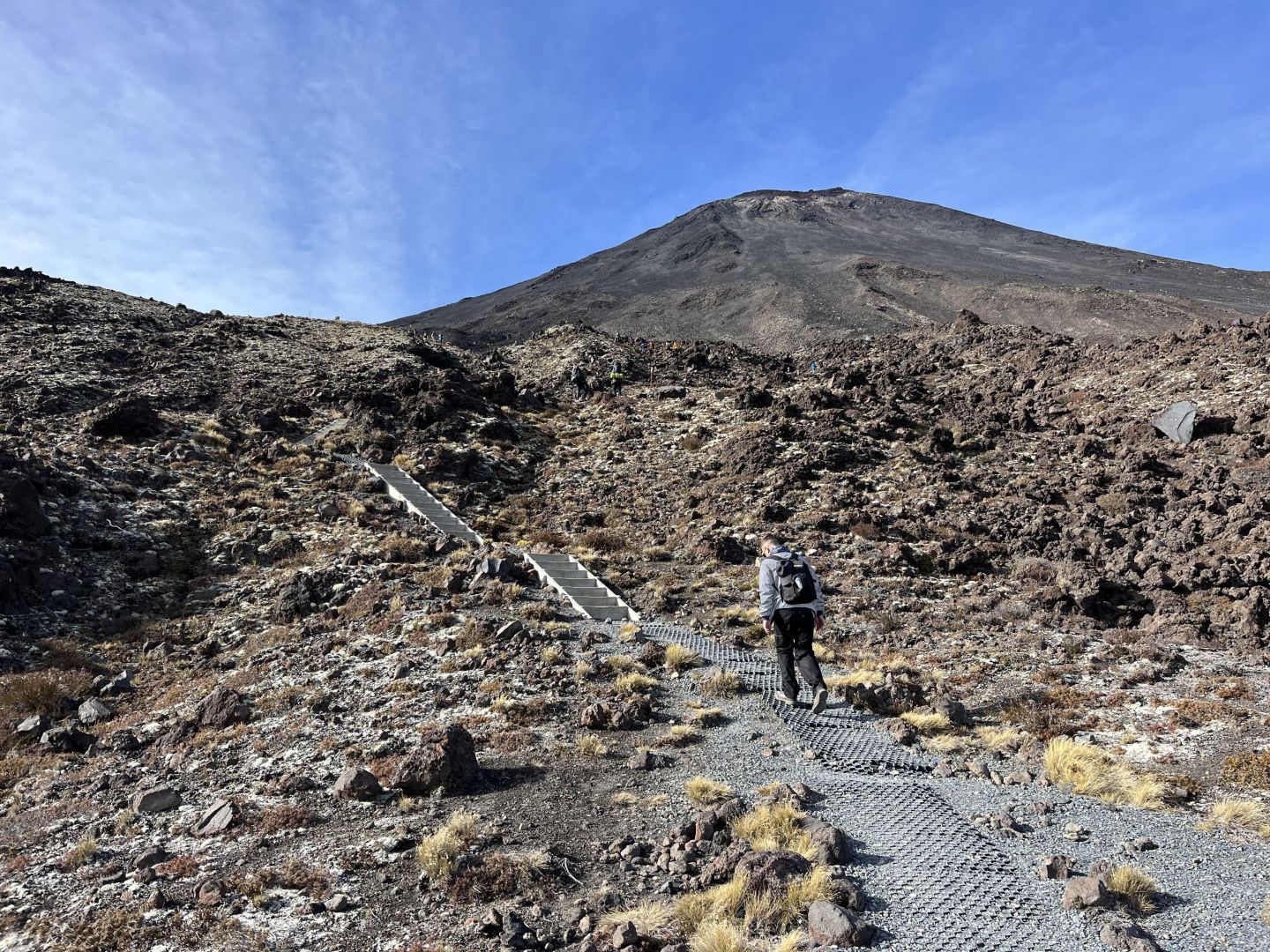 A hiker starting their ascent on the Devil's Staircase on the Tongariro Alpine Crossing