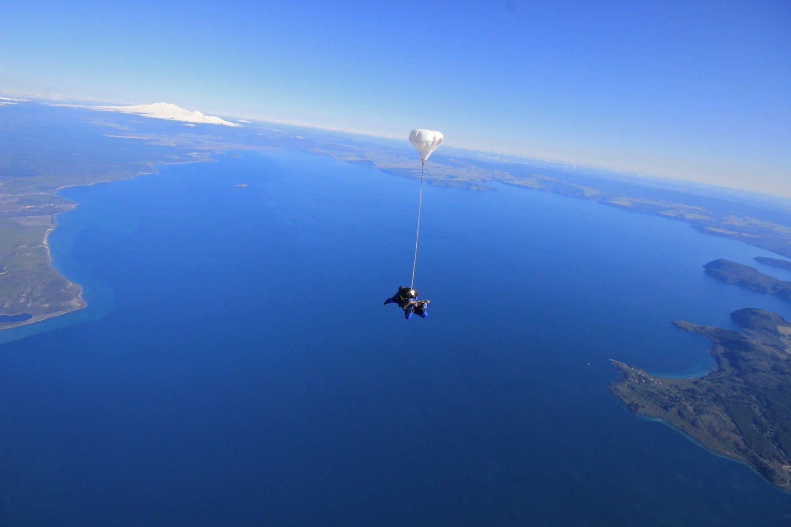 Skydivers over Lake Taupo from Skydive Taupo