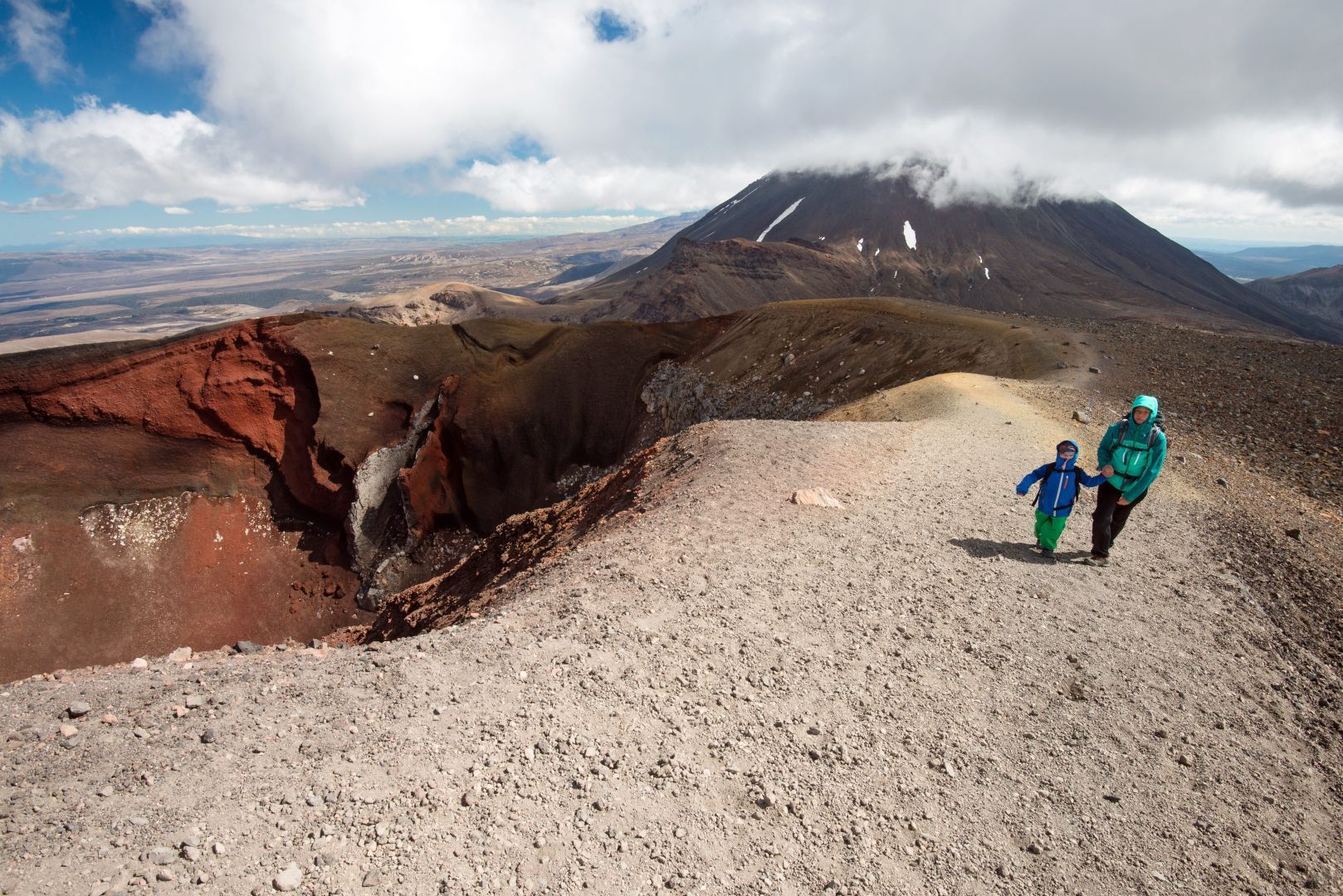 A family at the crater rim of the Tongariro Alpine Crossing