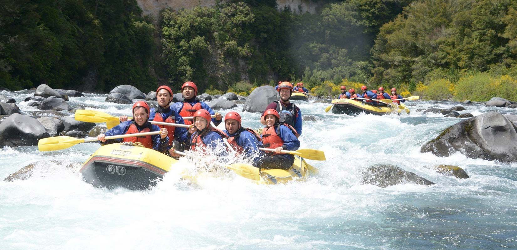 A group of people white water rafting on the Tongariro River