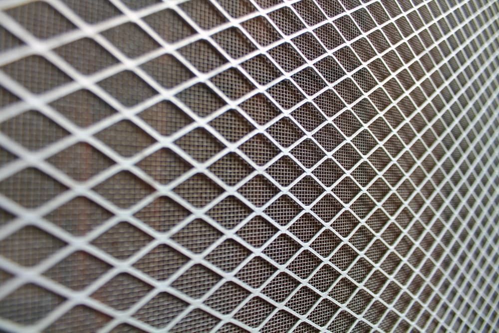 White diamond-patterned mesh overlaying a darker textured surface, creating a layered effect — Everything Screendoors & More In Wollongong, NSW