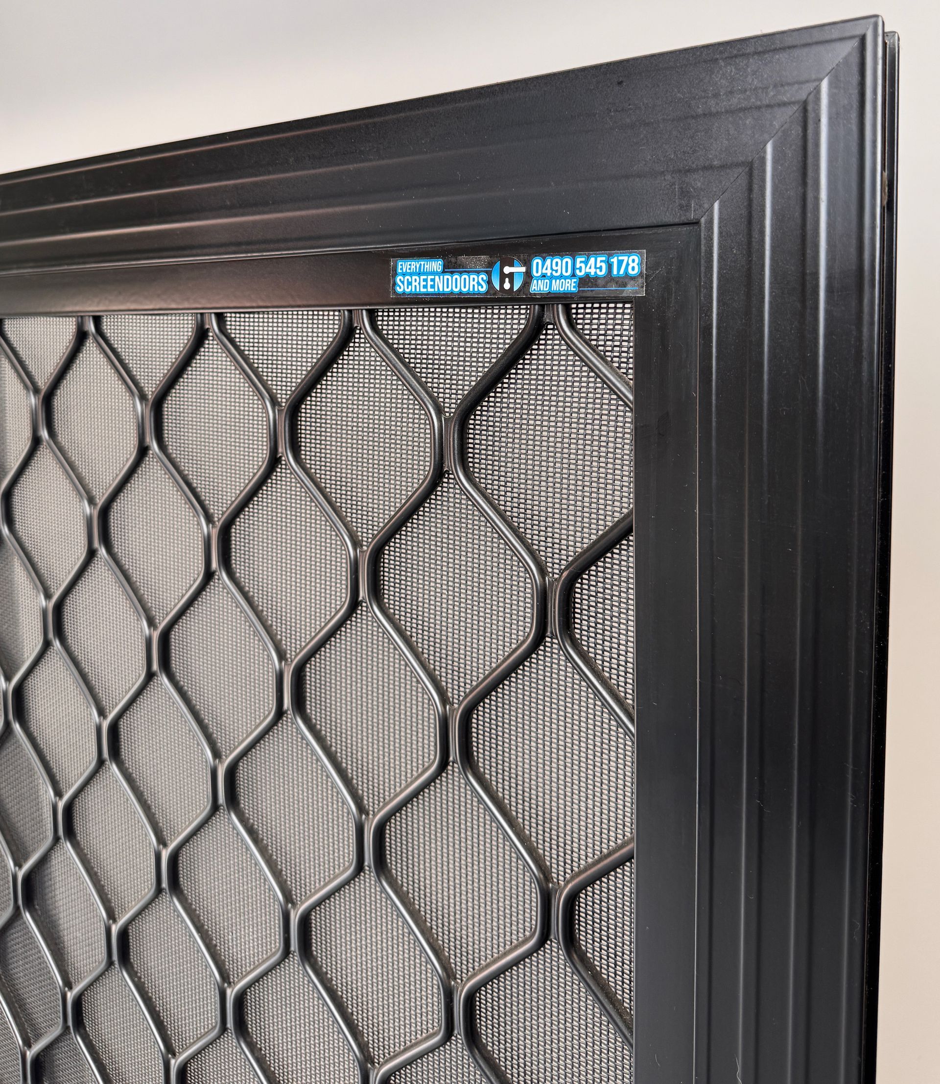 Black security screen door with diamond mesh — Everything Screendoors & More In Wollongong, NSW