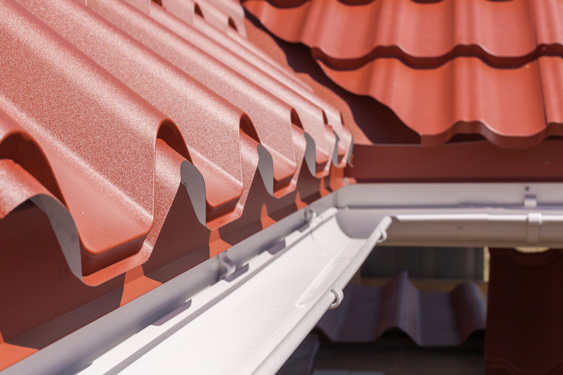 Red Roof Tiles With a White Gutter — JLH Plumbing, Gas & Roofing in South Nowra, NSW
