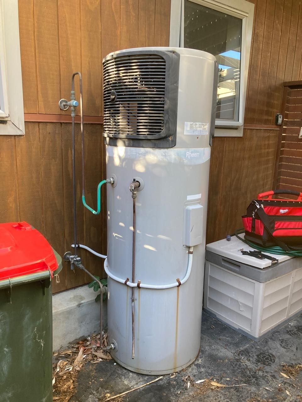 Tall, Cylindrical Water Heater With a Black Top — JLH Plumbing, Gas & Roofing in South Nowra, NSW