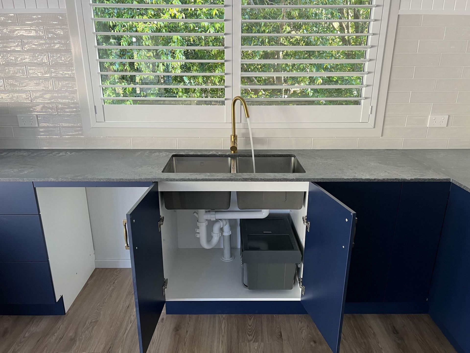 Kitchen Sink With Blue Cabinets — JLH Plumbing, Gas & Roofing in South Nowra, NSW