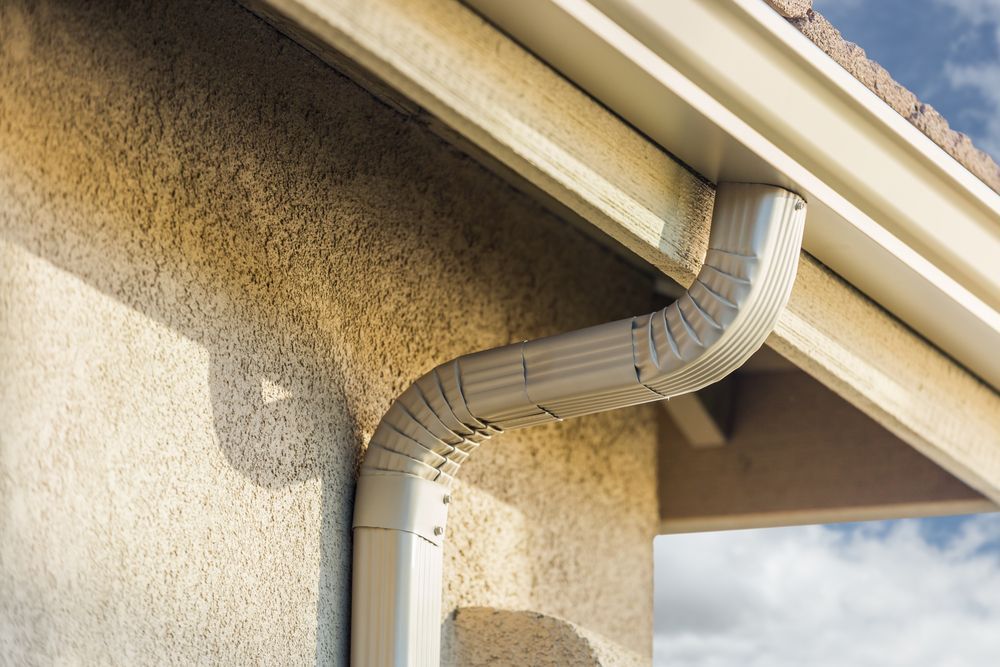 White Box Gutter System on a Tan Stucco House — Fullerton's Plumbing Manufacture In Woree, QLD