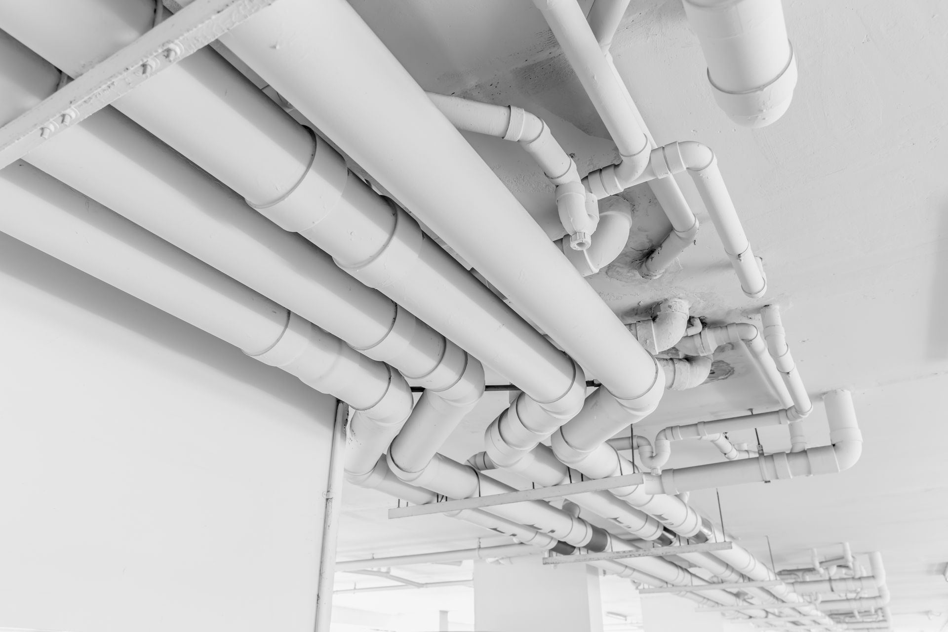 White Pipes Running Along a White Ceiling in a Building — Fullerton's Plumbing Manufacture In Woree, QLD
