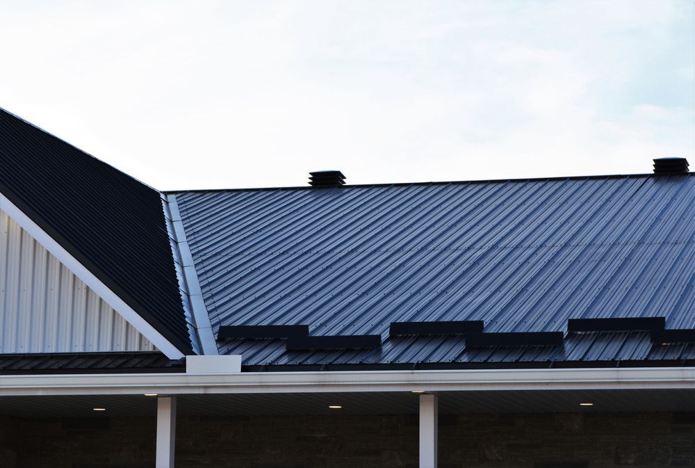 A Building With a Metal Roof — Fullerton's Plumbing Manufacture In Woree, QLD