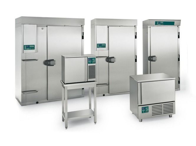 Four stainless steel commercial walk-in refrigerators and freezers on a white background