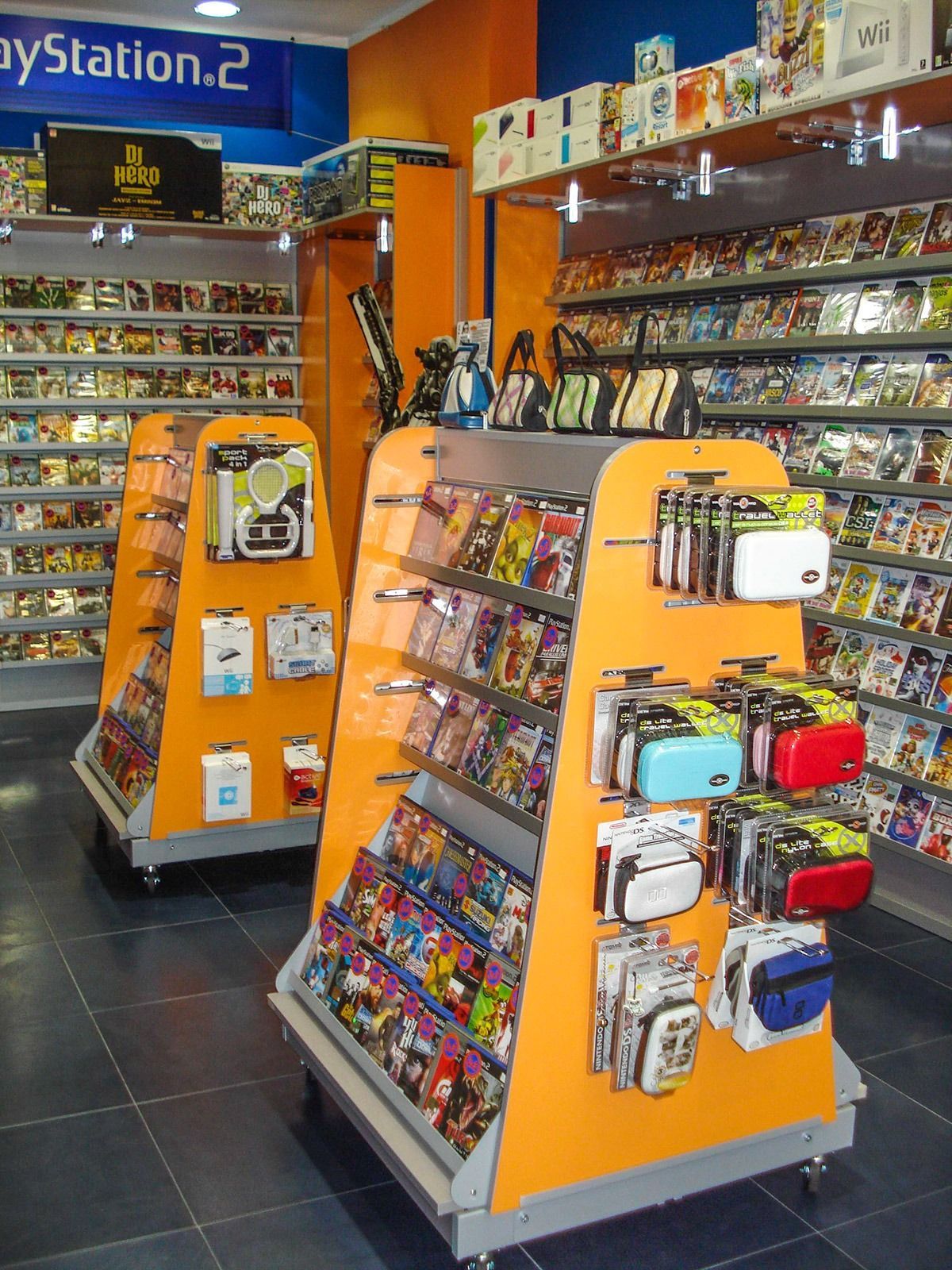 Orange retail display racks stocked with packaged items in a colorful store aisle