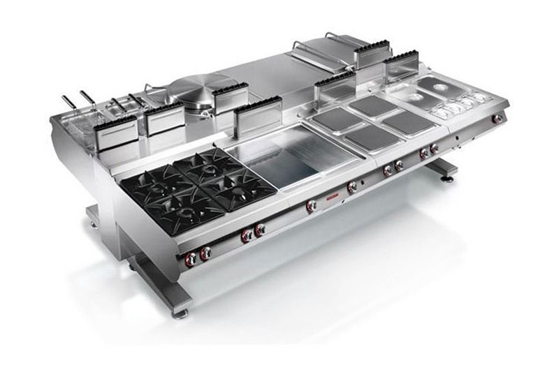 Stainless steel commercial kitchen range with burners, griddle, and prep trays