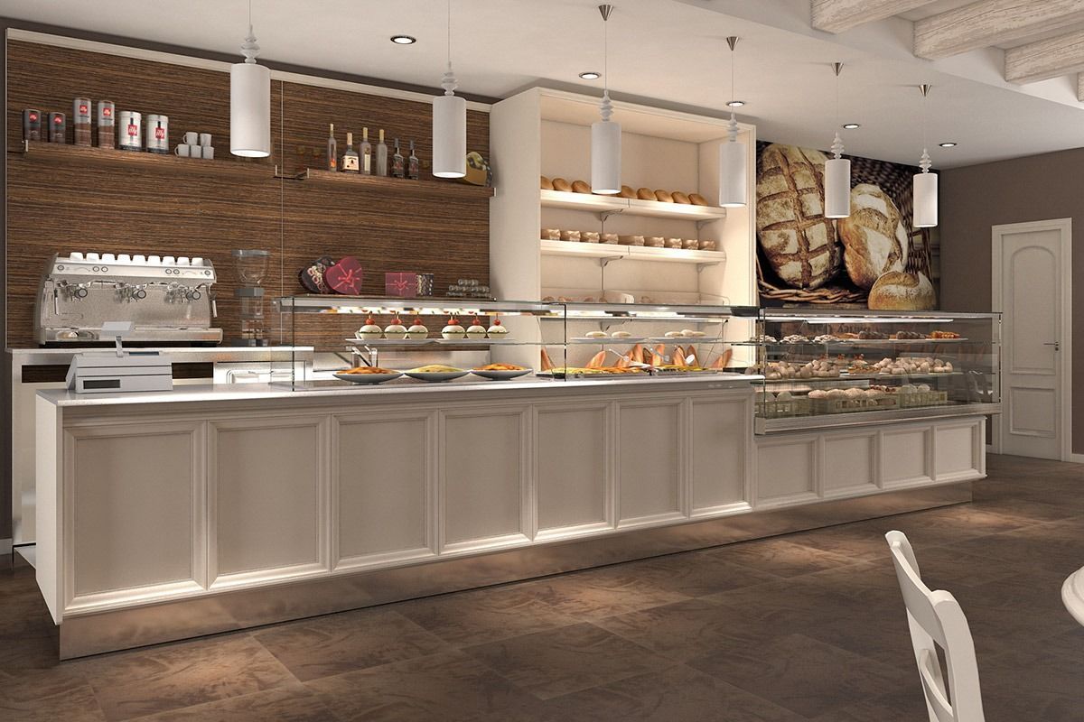 Elegant bakery counter with glass pastry cases, white cabinetry, and brick wall decor in a warmly lit interior