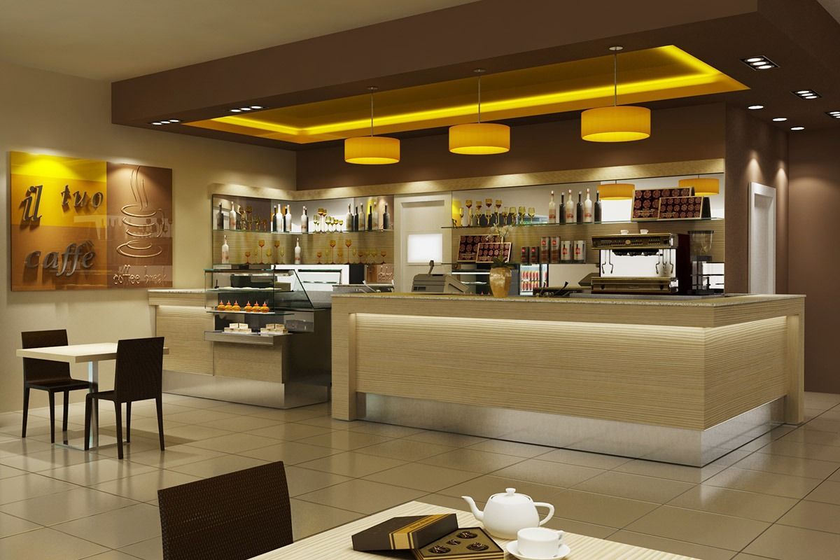 Modern café interior with warm lighting, beige counter, shelving, and small seating area