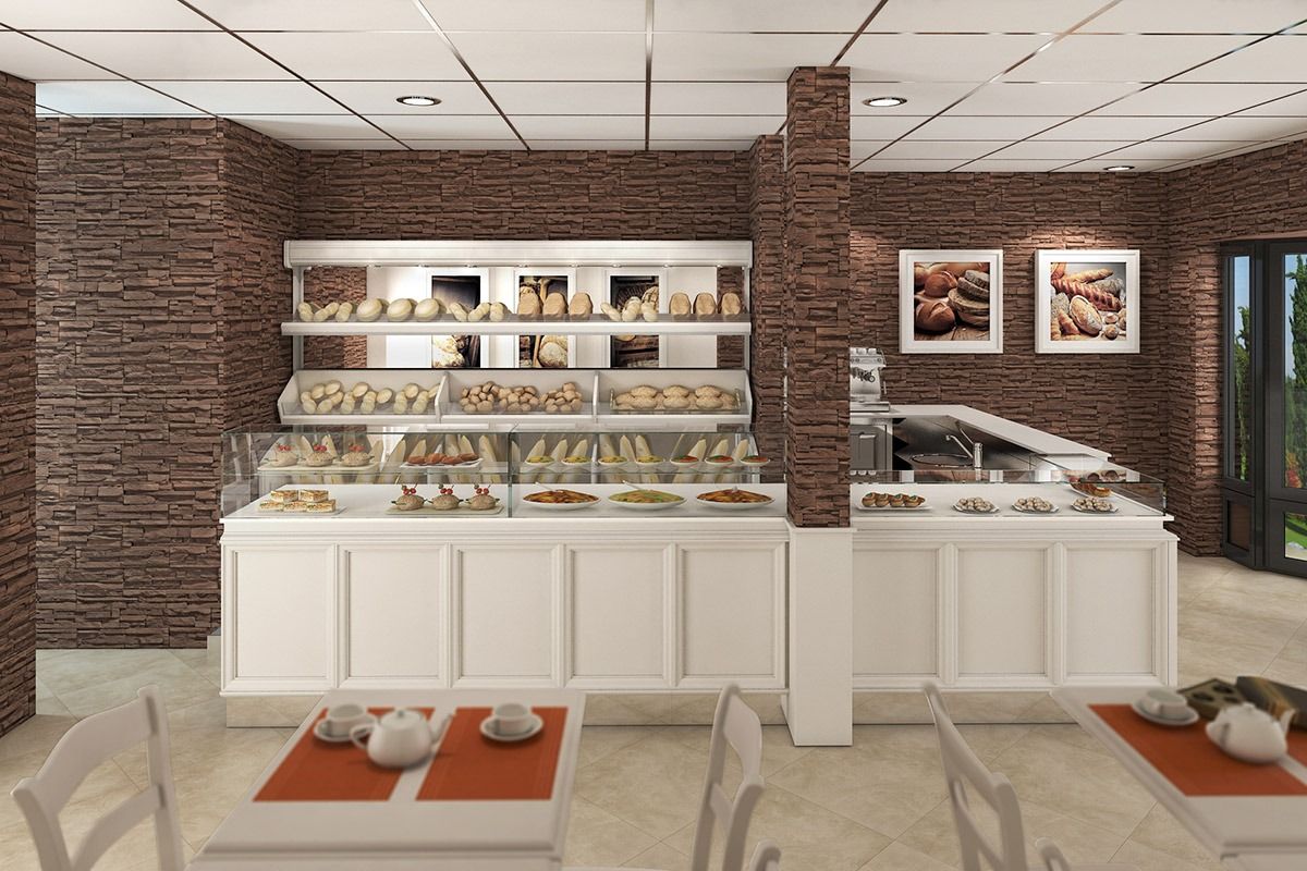 Upscale bakery interior with white display case, pastries, brick walls, and framed art