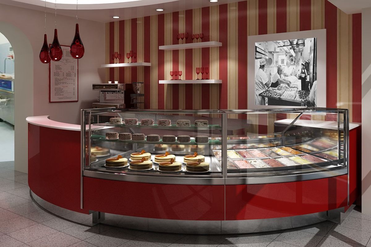 Red café display counter with pastries, red striped walls, and hanging pendant lights