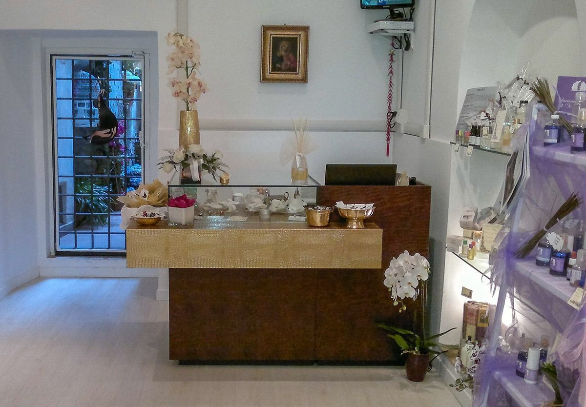 Small funeral reception room with a casket, flower arrangements, and memorial table