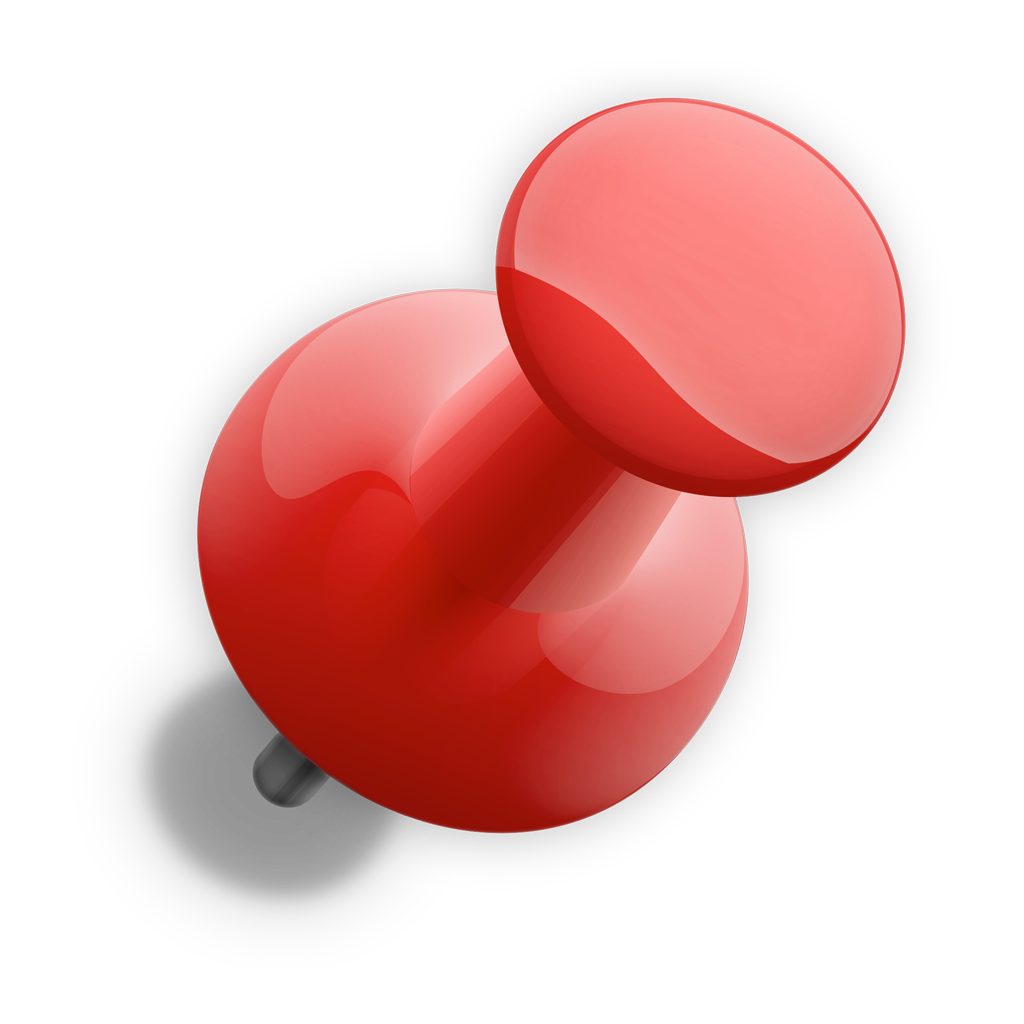 A red pin is sitting on a white surface