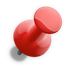 A red pin is sitting on a white surface