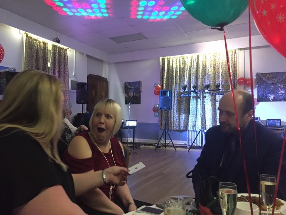 Party magician Manchester Paul Roberts performing at a Christening event using his award winning sleight of hand.