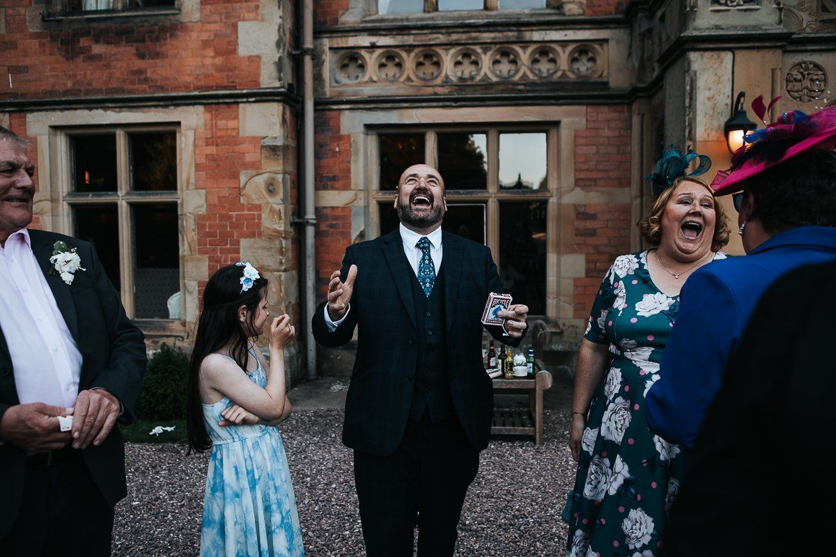 A group of people are standing in front of a building and laughing.