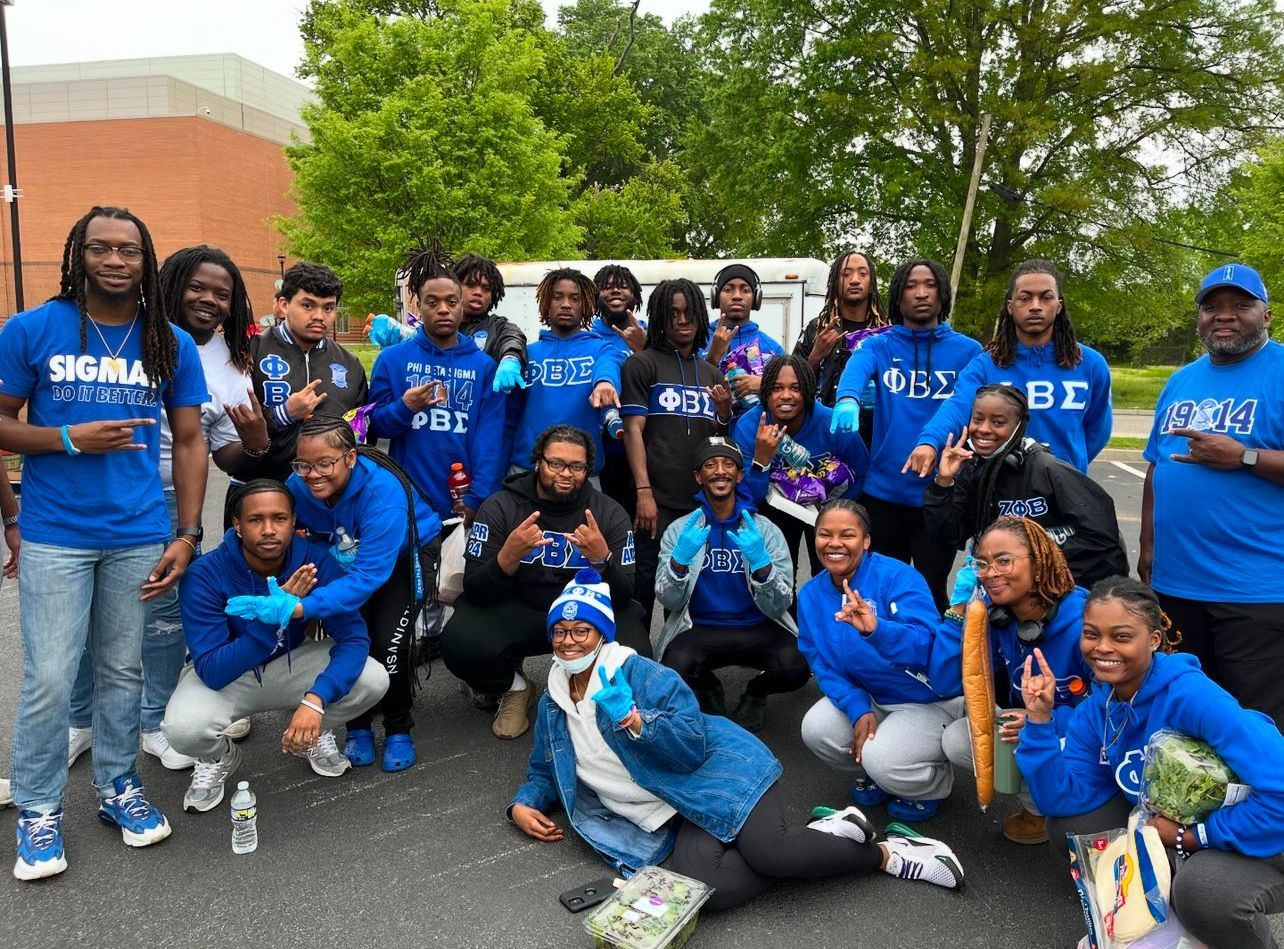 Group of people in blue, some wearing