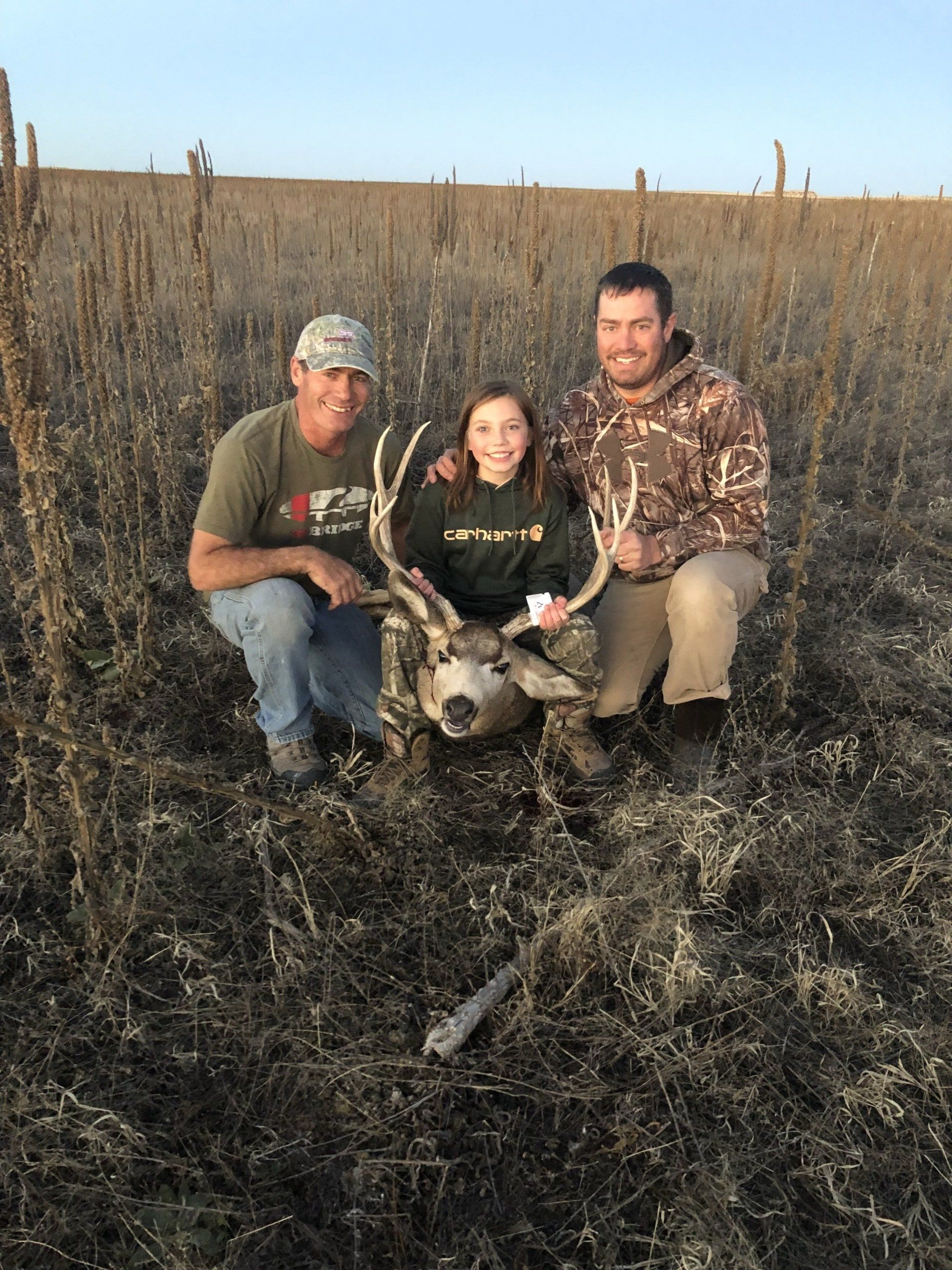 Sobo's guide Nate with father and daughter posing with trophy buck mule deer