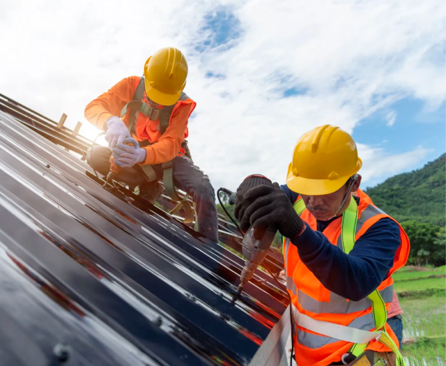 Eyles Contracting | Two construction workers are working on a roof.