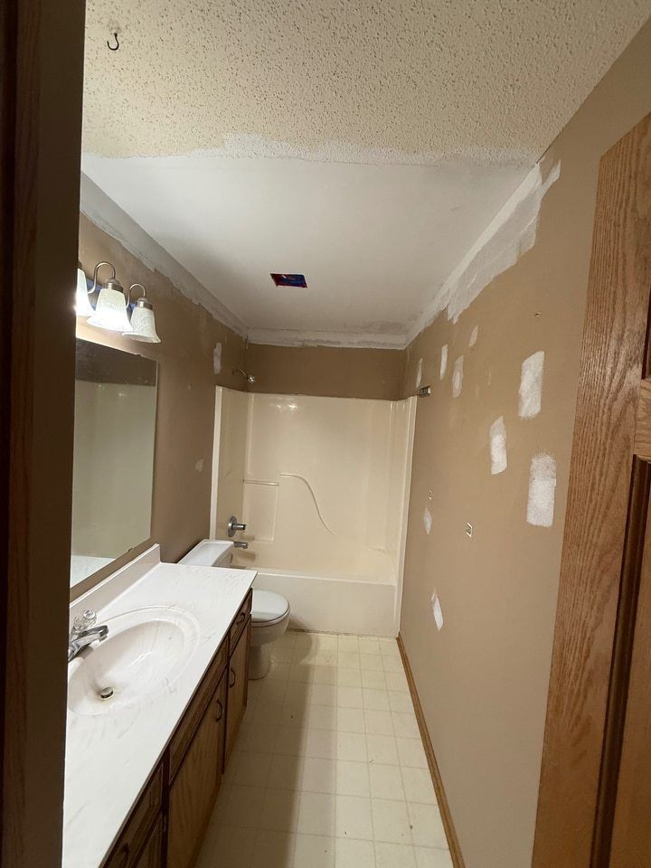Bathroom ceiling and wall repairs in progress before painting.