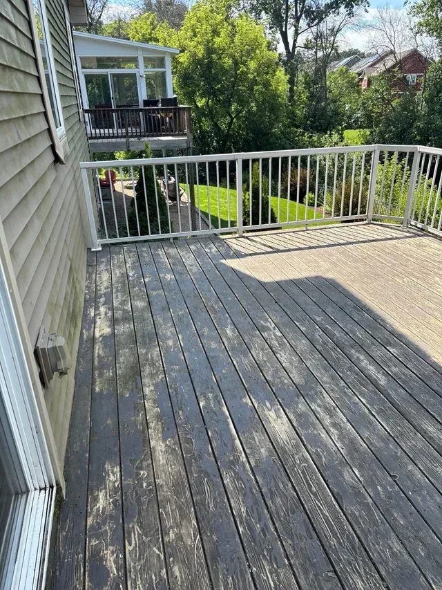 Weathered deck boards with white railing
