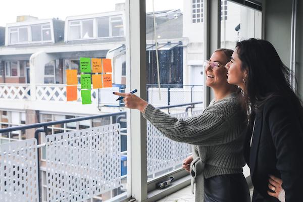 Women looking at post it notes