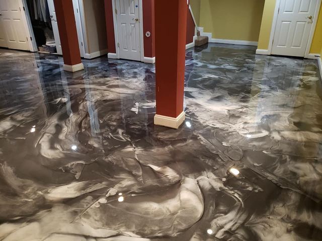 a basement with a marble floor and a staircase .