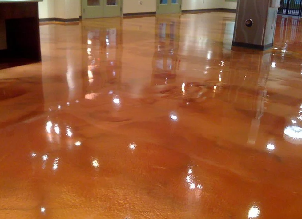 a shiny metallic floor in a room with a fireplace .