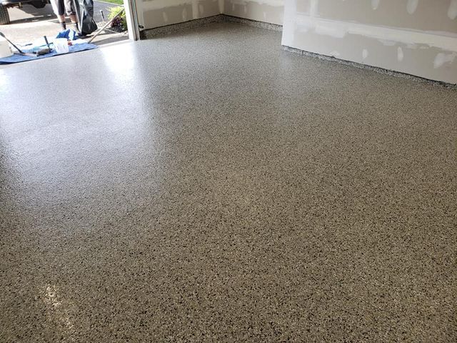 a close up of a garage floor with a mop on it .