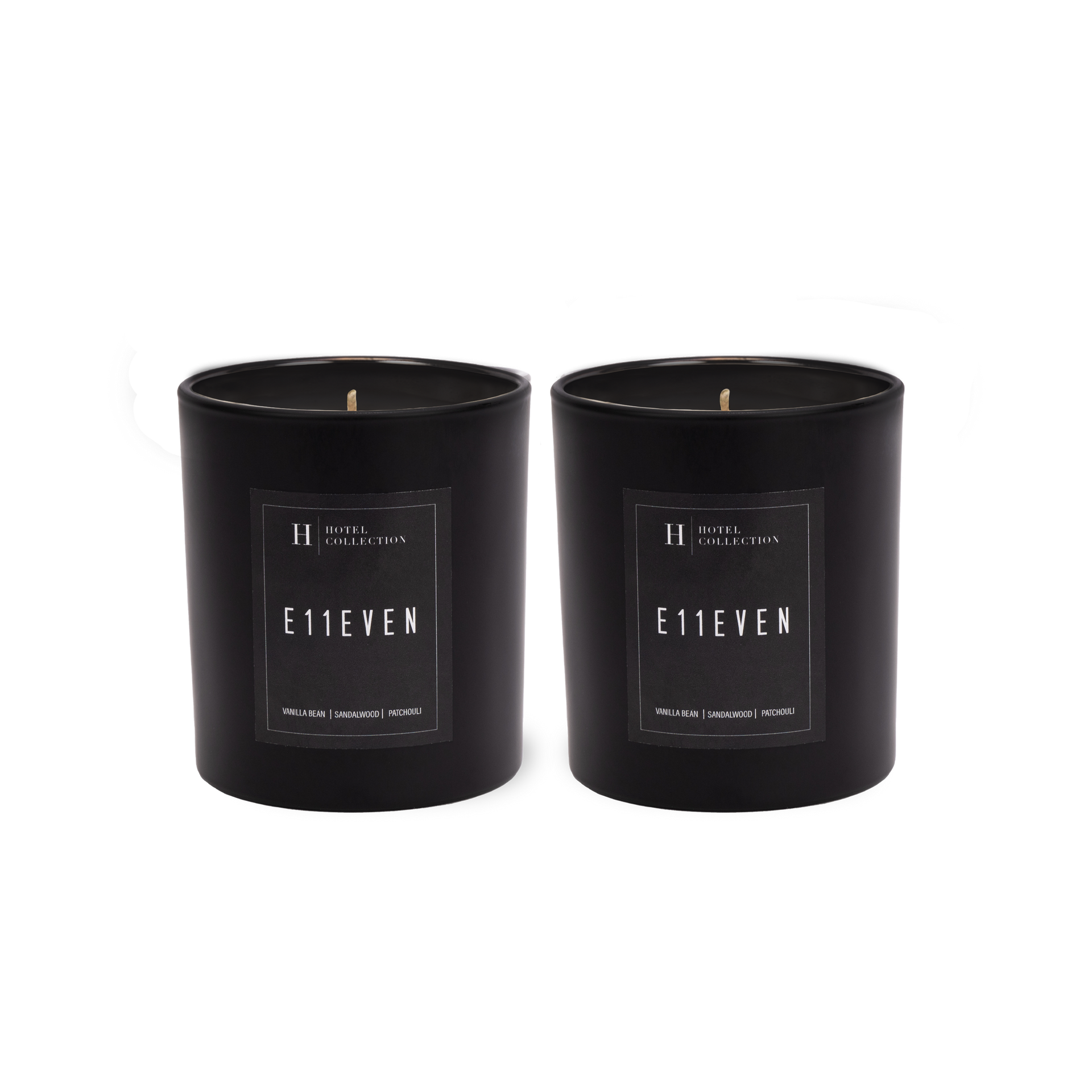 Two black candles with labels on them on a white background.