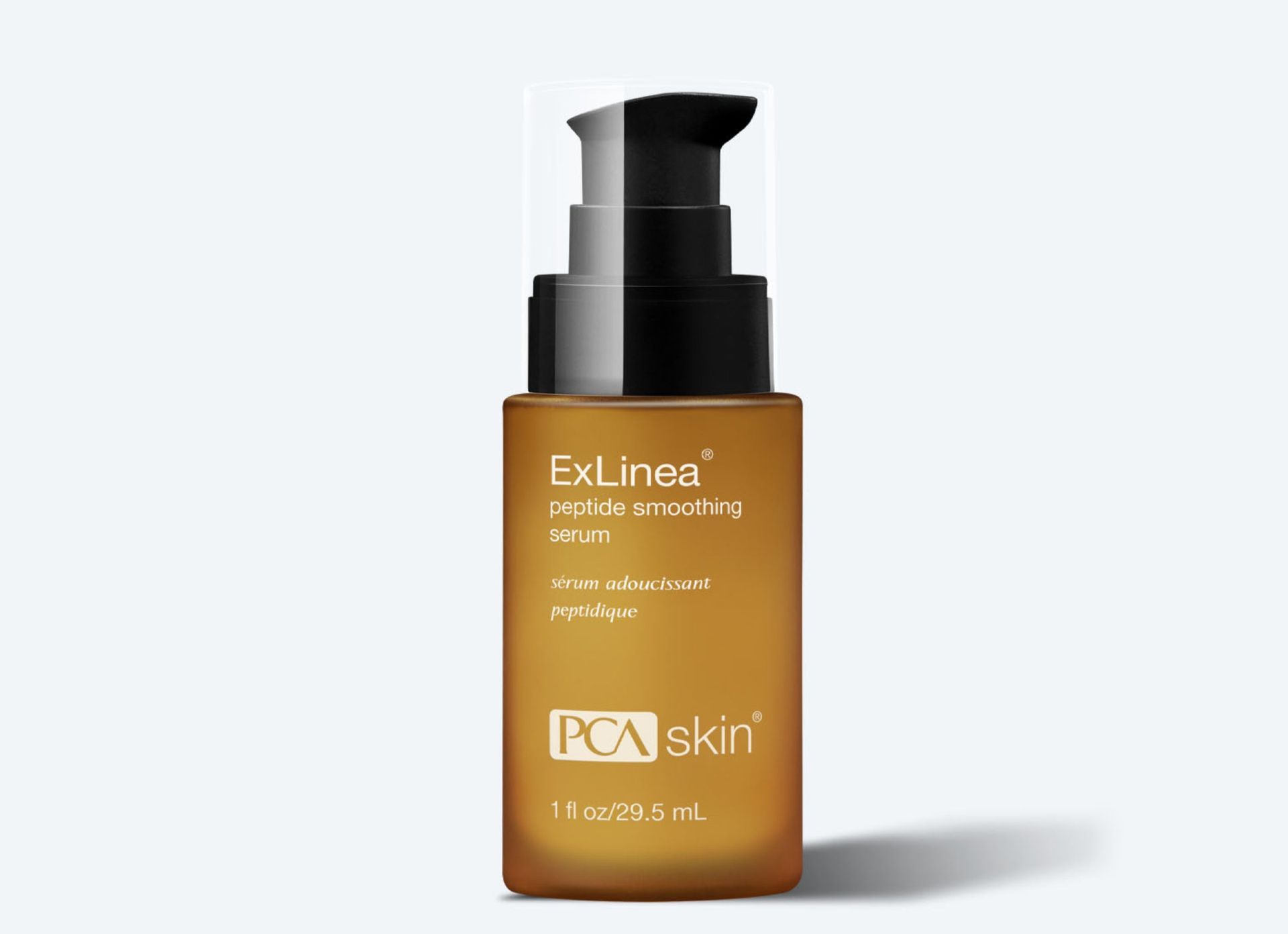 A bottle of pca skin serum is sitting on a white surface.