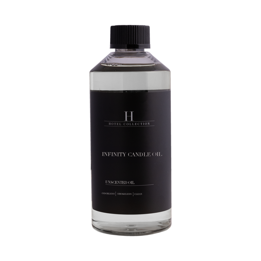 A bottle of infinity candle oil with a black label on a white background.
