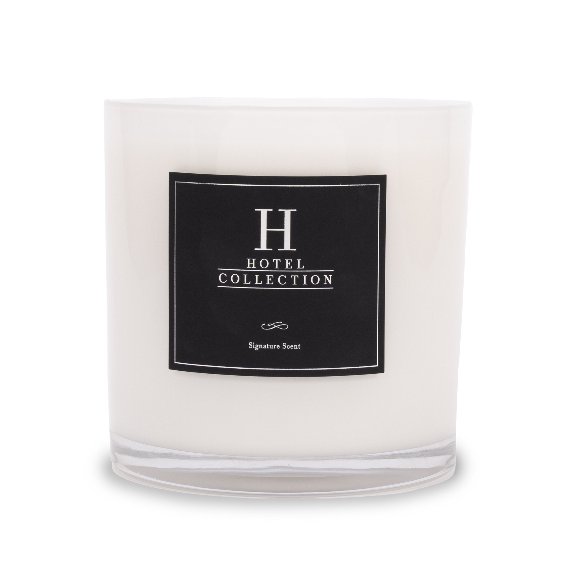 A white candle with a black label that says hotel collection