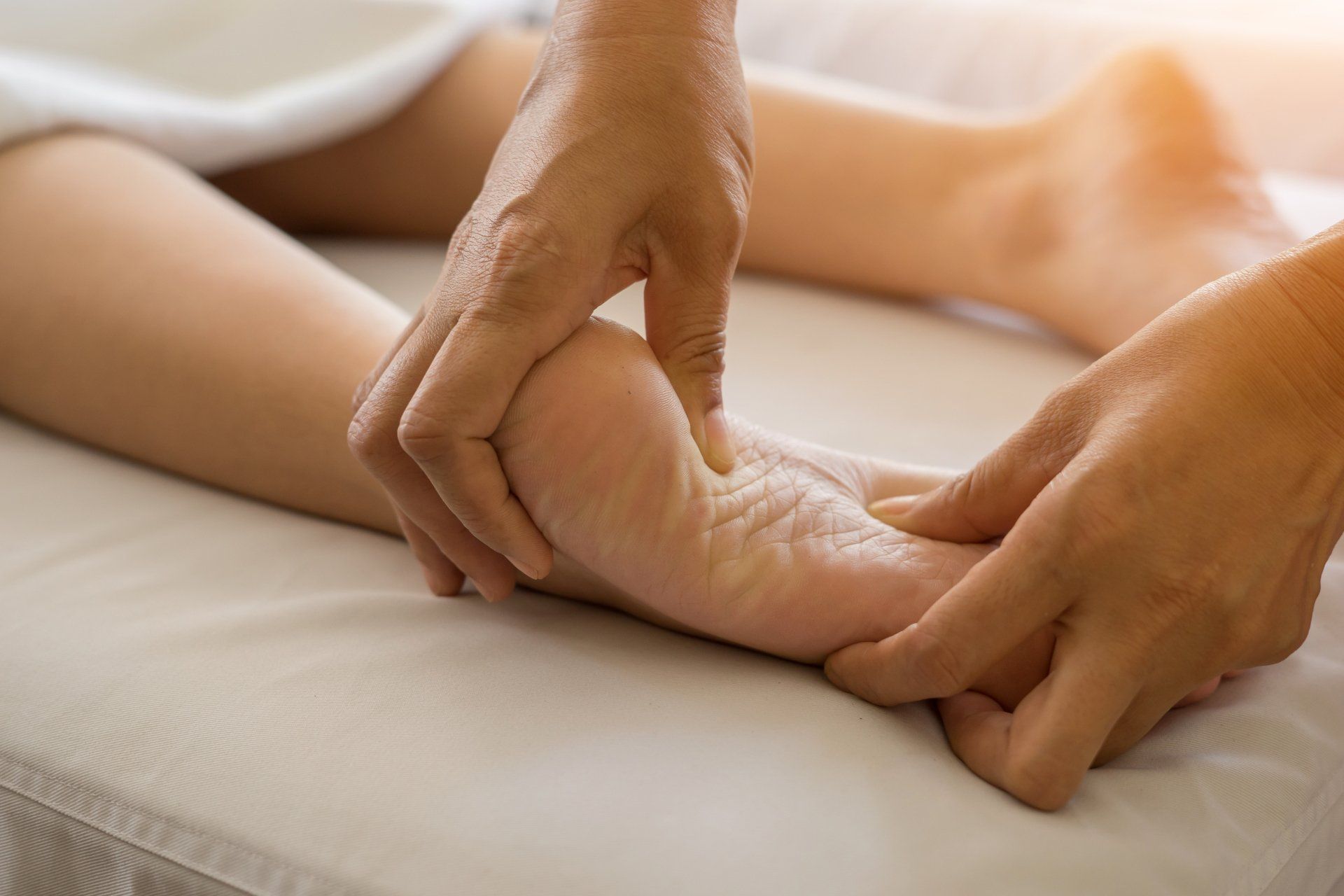 A person is getting a foot massage from a massage therapist.